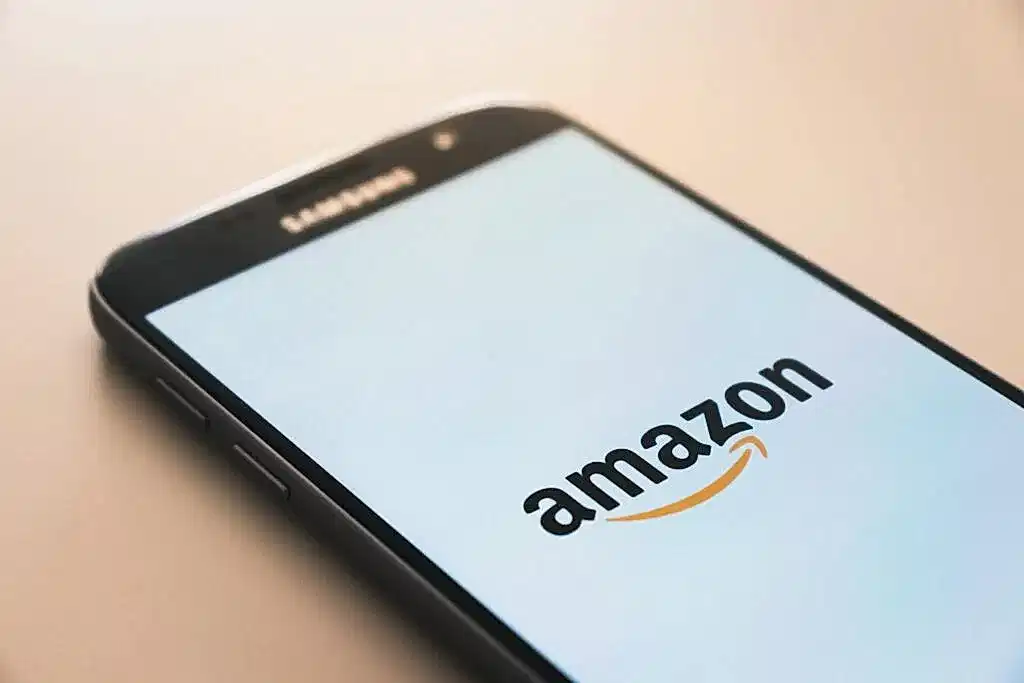 A bride to be uses her phone to open the Amazon app and add items to her registry.