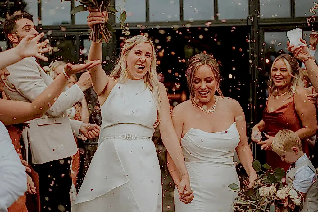 A bride makes her grand entrance at the wedding reception while listening to one of the best wedding songs from our list
