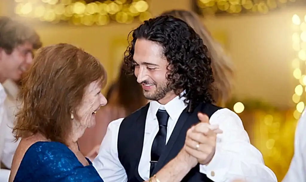 A mother and son dance to their chosen song at a wedding reception